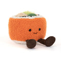 Plush toy resembling a roll of sushi with a smiling face on a white background