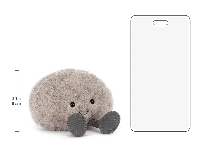 Plush toy resembling a round grey pebble with a smiling face on a white background with measurements
