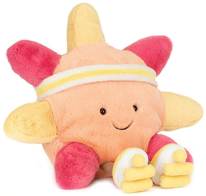 Plush toy sun with a smiling face, pink and yellow accents on a white background