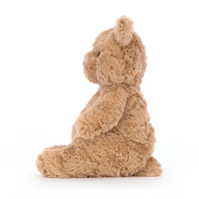 Brown teddy bear sitting on a white background