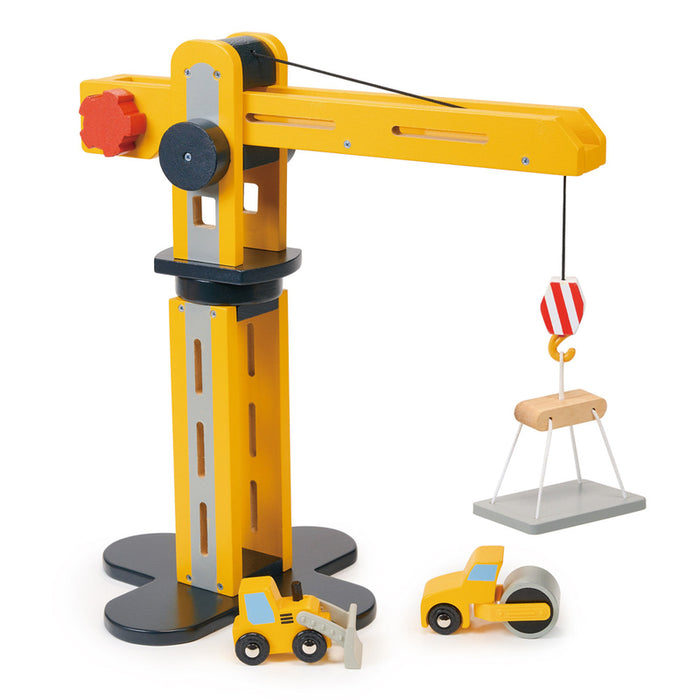 A wooden construction play set featuring a yellow crane with a movable arm and platform, two construction vehicles, and a lifting hook.