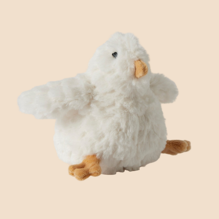 Plush toy resembling a white chicken with brown feet on a beige background