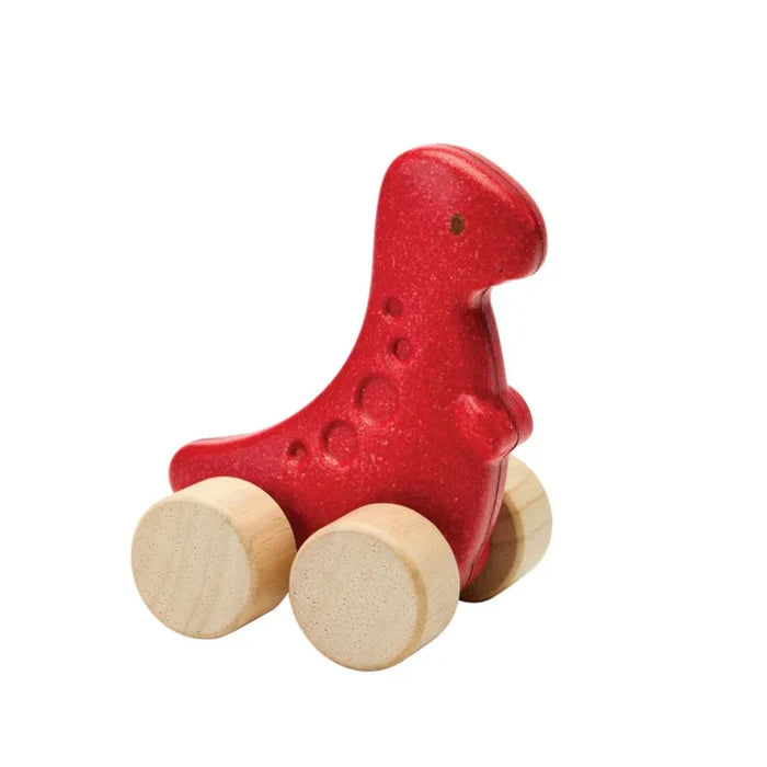 Red dinosaur-shaped toy with wooden wheels on a white background