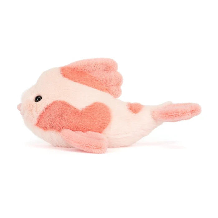 Plush toy fish with a heart pattern on a white background
