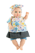 A soft body doll with a vinyl head and limbs, dressed in a floral skirt and a patterned top, with a bow on the head.