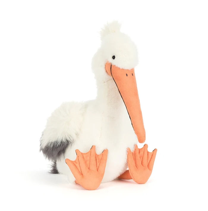 Pelican soft toy with orange beak and feet on a white background