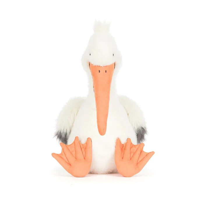 Stuffed pelican toy with a white body, orange beak, and feet on a white background