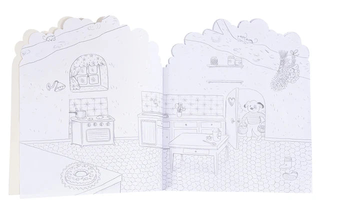 A children's coloring book or activity booklet shown open, featuring a black-and-white line drawing of a cozy kitchen scene with a panda character on the right page.