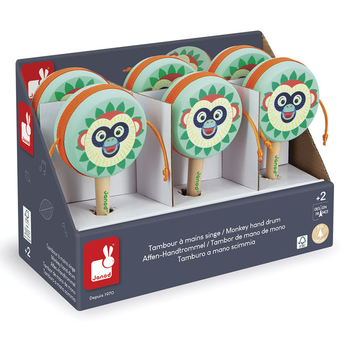 Box of Janod monkey hand drums with colorful monkey designs on a white background