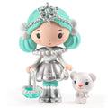 Toy figure of a girl with turquoise hair and silver outfit holding a small basket and with a small white bear on a white background