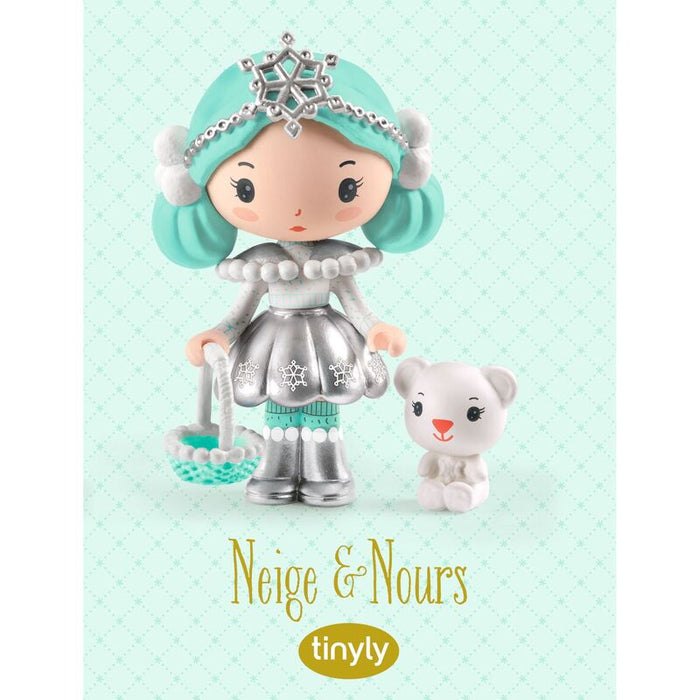 Toy figure with turquoise hair and silver outfit on a light green background, featuring the brand 'tinyly'.