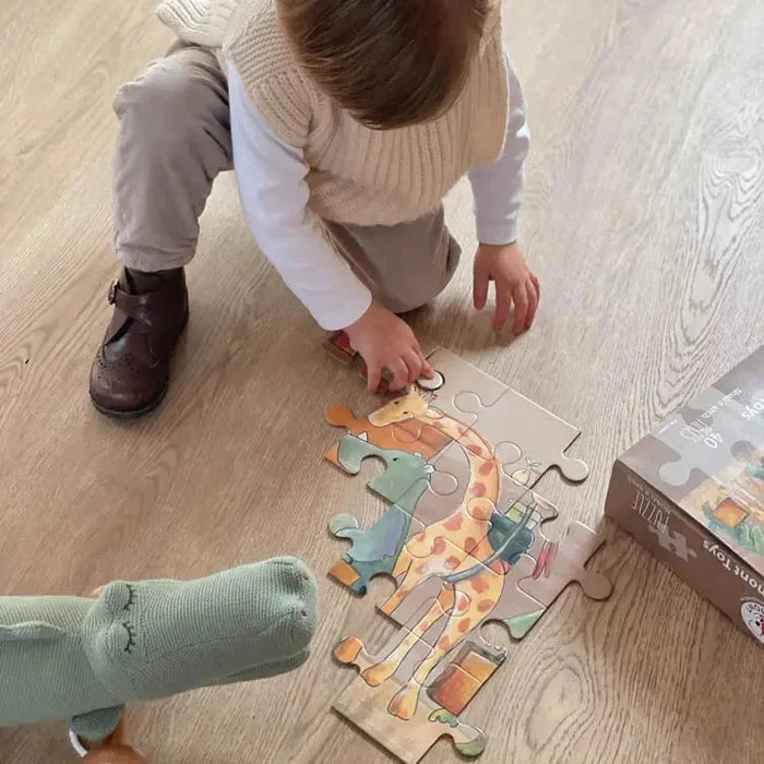 Child playing with a puzzle on a wooden floor