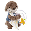 A plush toy otter holding a colorful rattle ring with beads in its handle, designed for babies and toddlers.