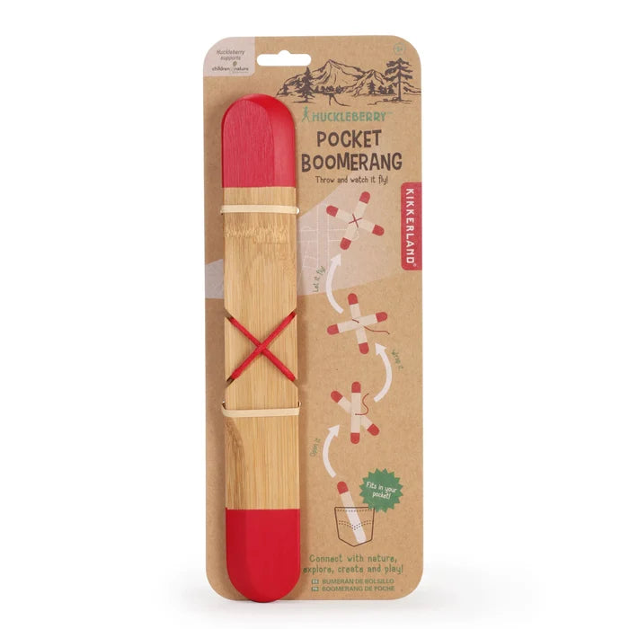 A red and wooden pocket boomerang toy packaged on a cardboard backing with illustrations showing how to assemble and throw the boomerang.