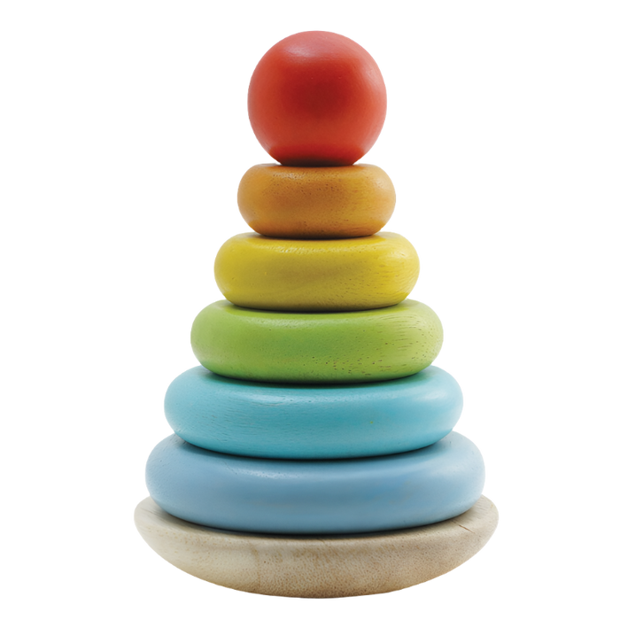 A wooden stacking toy consisting of a wobbly base and six colorful stackable rings in increasing sizes from bottom to top.