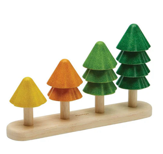 Set of wooden trees with different colored tops on a wooden base