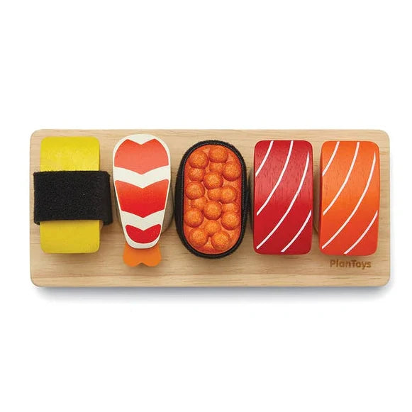 Wooden toy sushi set on a wooden board with PlanToys branding.