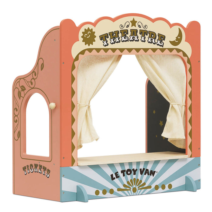 A colorful tabletop puppet theater with a show curtain, ticket window booth, and chalkboard showtime board. The theater is designed with a vibrant, theatrical backdrop and gold paint details.