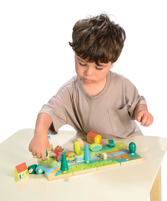 Child playing with a wooden toy on a white background