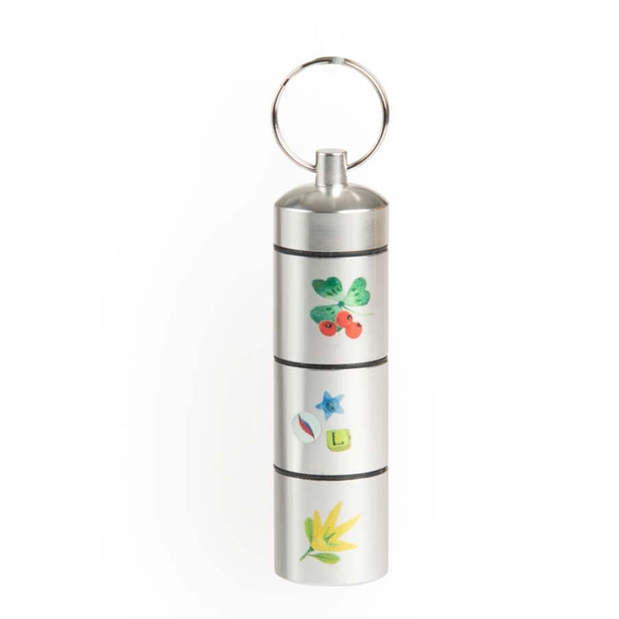 Small silver metal treasure capsule with flower motifs