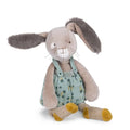 Stuffed bunny toy with a green polka dot outfit on a white background